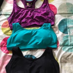 Black, teal, and pink sports bras